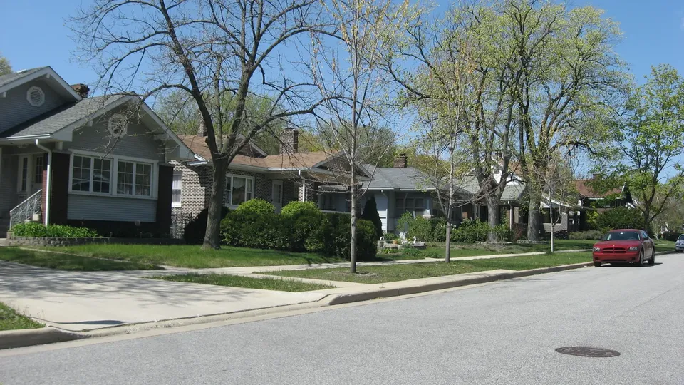 Brick bungalows set close together along a residential street with narrow front gardens